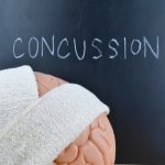 Concussion (traumatic brain injury) and head impact may accelerate brain aging