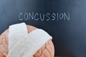 Concussion (traumatic brain injury) and head impact may accelerate brain aging