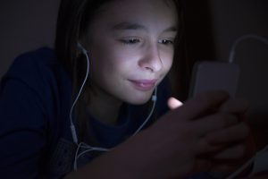 Teenager listening music on the bed