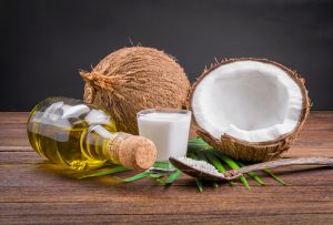 Coconut milk and coconut oil on wooden table