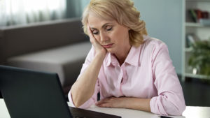 Mature woman falling asleep at workplace, lack of vitamins and energy, tired
