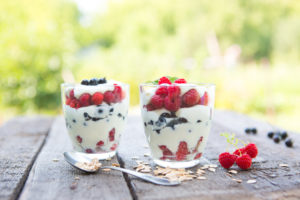 Natural yogurt with fresh raspberries, black currant and muesli. . Healthy dessert. Healthy food concept.