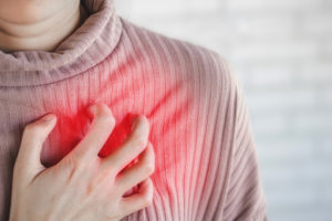 Asian woman hand touching her chest having heart attack, healthcare and medical concept