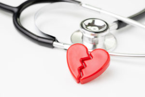 Heart attact or broken heart concept, cute read heart break with medical stethoscope on white background, health care, patient diagnostic and prevention.