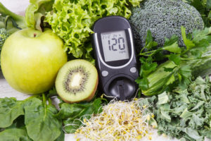 Glucometer for measuring sugar level and vegetables with sprouts as healthy nutritious food during diabetes containing vitamins and minerals