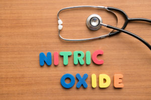 Nitric oxide colorful word with stethoscope on the wooden background