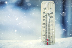 Thermometer on snow shows low temperatures under zero. Low temperatures in degrees Celsius and fahrenheit. Cold winter weather twenty under zero.Thermometer on snow shows low temperatures under zero. Low temperatures in degrees Celsius and fahrenheit. Cold winter weather twenty under zero.