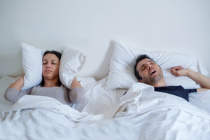 Woman can't sleep because her boyfriend is snoring loudly
