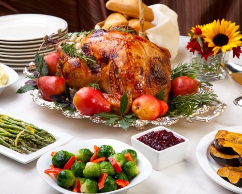 Delicious roasted turkey with savory vegetable side dishes in a fall theme.