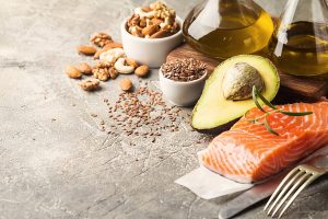 Healthy fats in nutrition - salmon, avocado, oil, nuts. Concept of healthy food