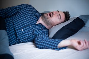 Man snoring and suffering sahs at night