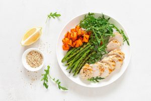 Grilled chicken breast, fillet with butternut squash or pumpkin, green beans and fresh arugula salad, healthy food, top view