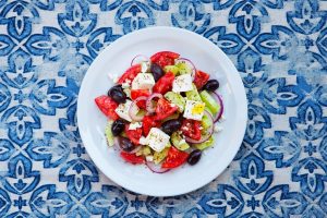 Greek salad. Fresh vegetables, feta cheese and black olives. Top view.