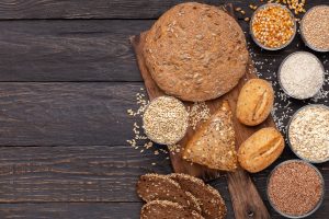 Healthy lifestyle. Wholegrain bread with gluten free grains on wooden background, copy space