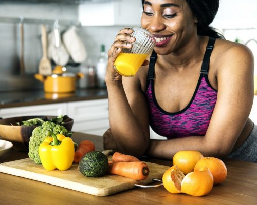 Black woman is drinking orange juice