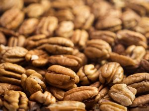 Pecan nuts background. Closeup pekan seeds. Nobody