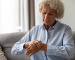 Unhappy senior old hoary woman touching wrist joint, suffering from injured hand. Frustrated stressed middle aged mature female retiree having painful feelings in bones, arthritis osteoporosis concept