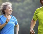 Happy Senior Couple jogging in the nature park