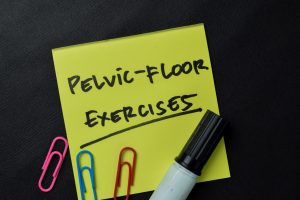 Pelvic-Floor Exercises write on sticky notes isolated on office desk.