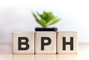 BPH concept on wooden cubes and flower in a pot in the background