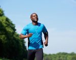 Portrait of an active african american man running exercise workout outdoors