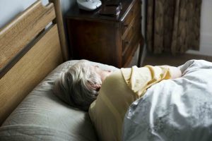 Elderly caucasian woman sleeping on the bed
