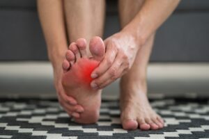 Foot pain, man suffering from foot pain at home, podiatry concept