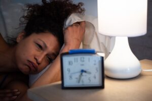 Tired black woman suffering sleeping disorder