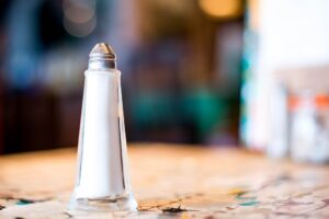 Single Salt Dispenser Or Shaker On A Restaurant or Cafe Table