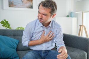 Man suffering from gastric reflux after dinner