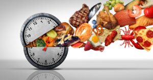 Intermittent fasting concept and calorie restriction or autophagy diet symbol nutrition concept and binge eating disorder with an open clock icon releasing food with 3D illustration elements.